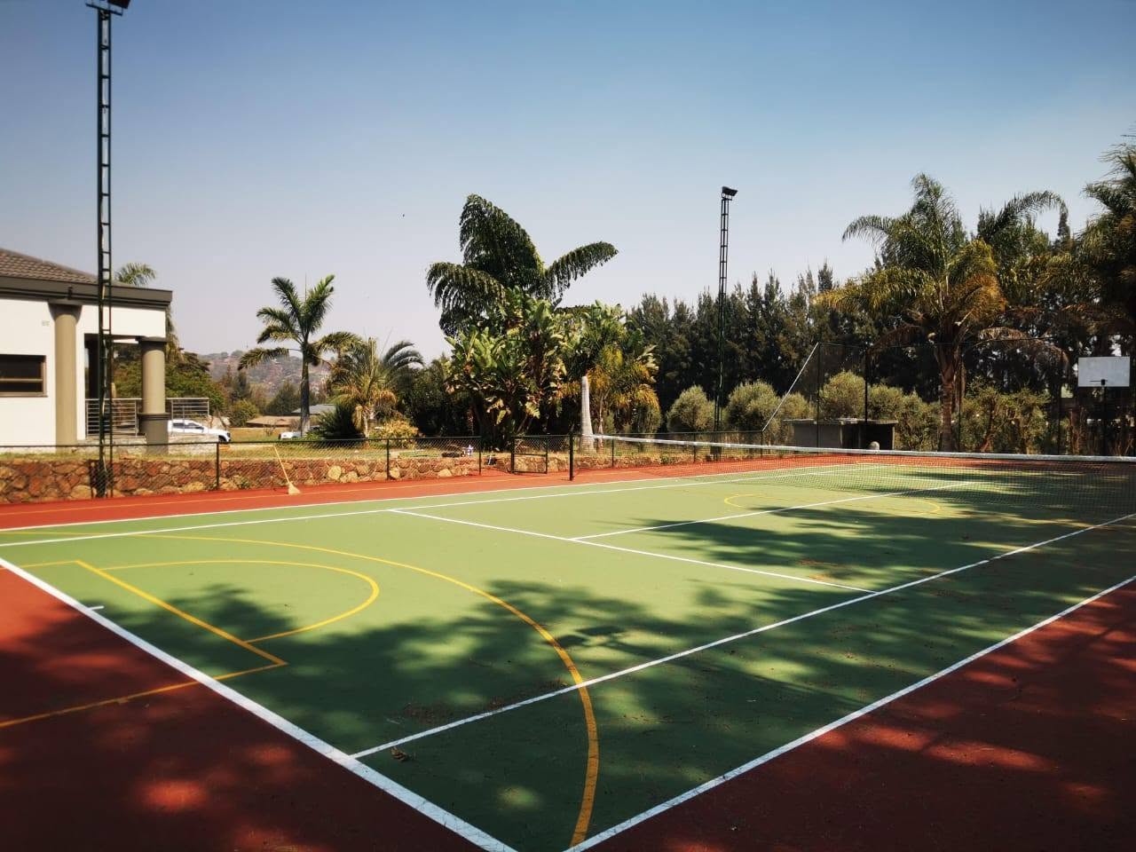 Freshly built tennis court with palm trees, constructed by Vebrech Civil Works